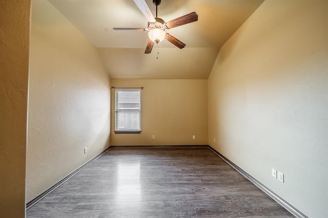 spare room with ceiling fan, lofted ceiling, and dark hardwood / wood-style flooring