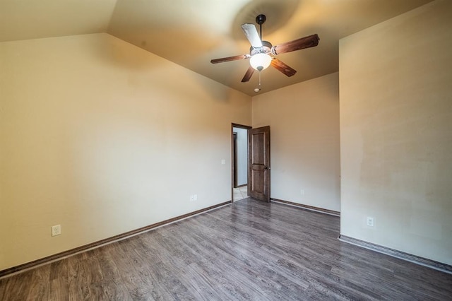 unfurnished room with vaulted ceiling, ceiling fan, and dark hardwood / wood-style flooring