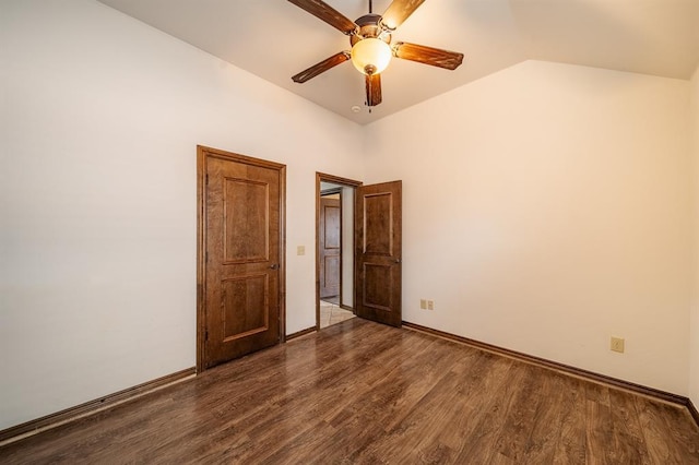 unfurnished bedroom with vaulted ceiling, dark wood-type flooring, and ceiling fan