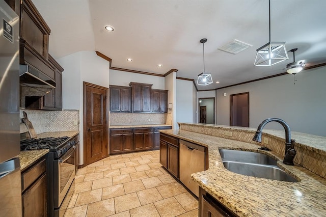 kitchen with tasteful backsplash, sink, hanging light fixtures, light stone counters, and stainless steel appliances