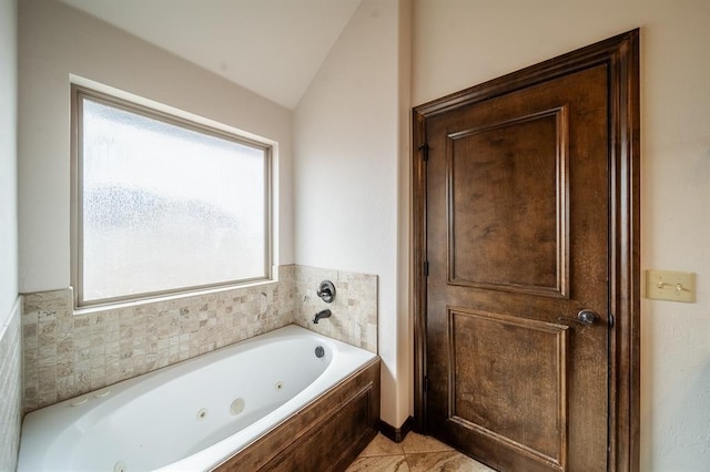 bathroom featuring lofted ceiling and a bathing tub