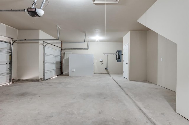 garage with a garage door opener and electric panel