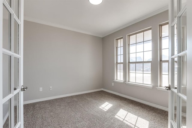 carpeted spare room with french doors and crown molding