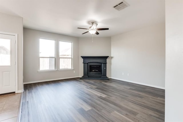 unfurnished living room with ceiling fan and hardwood / wood-style floors