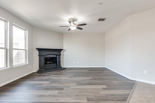 unfurnished living room featuring wood-type flooring and ceiling fan