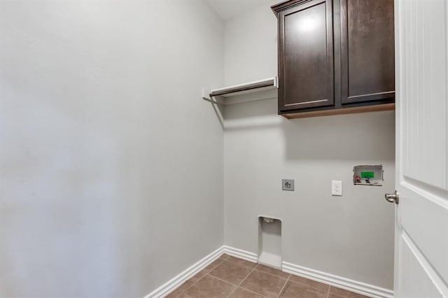 washroom featuring hookup for a washing machine, electric dryer hookup, tile patterned floors, and cabinets