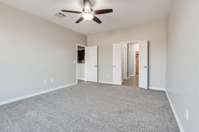 unfurnished bedroom featuring carpet floors and ceiling fan