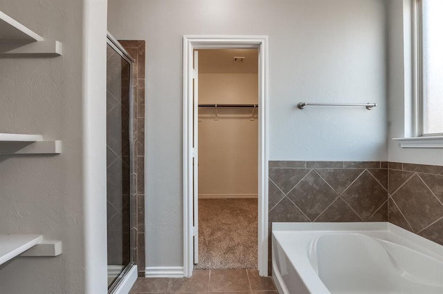 bathroom featuring tile patterned flooring and independent shower and bath