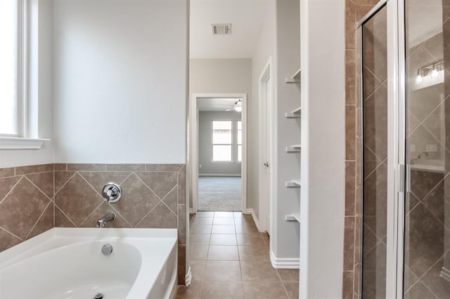 bathroom with separate shower and tub and tile patterned floors