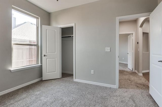 unfurnished bedroom featuring carpet floors and a closet