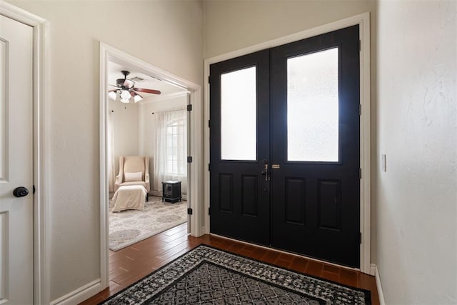 entrance foyer with dark hardwood / wood-style floors and french doors