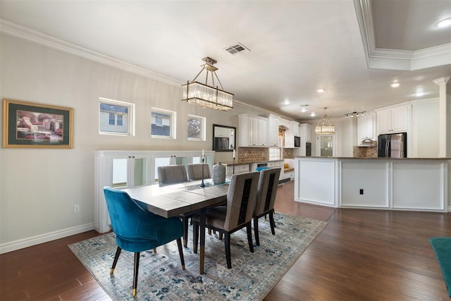 dining room with crown molding and dark wood-type flooring