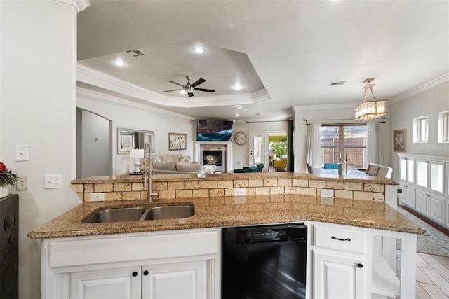 kitchen featuring a stone fireplace, sink, crown molding, dishwasher, and white cabinets