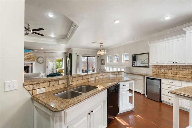 kitchen with pendant lighting, dishwasher, white cabinetry, tasteful backsplash, and dark hardwood / wood-style flooring