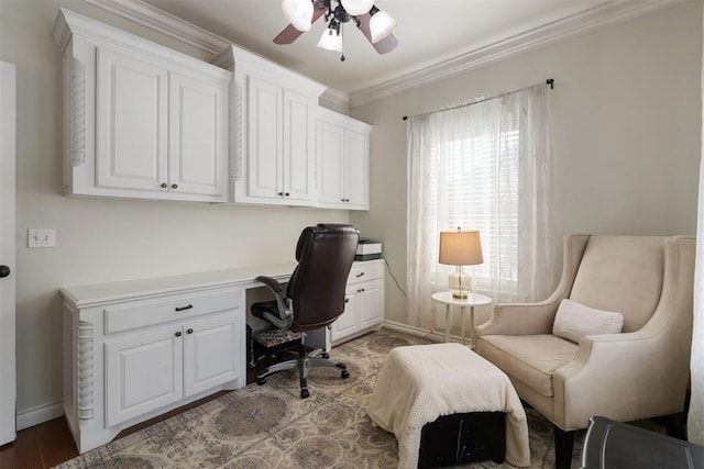 office area featuring built in desk, ornamental molding, and ceiling fan