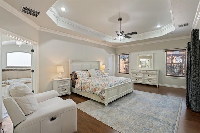 bedroom with a raised ceiling, crown molding, dark wood-type flooring, and ceiling fan