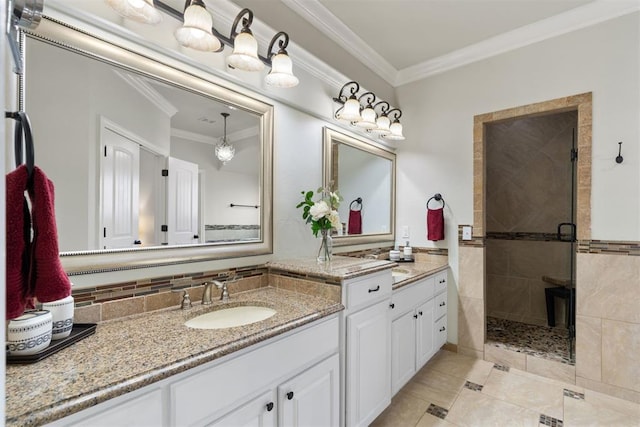 bathroom with vanity, tile patterned floors, a shower with shower door, and ornamental molding