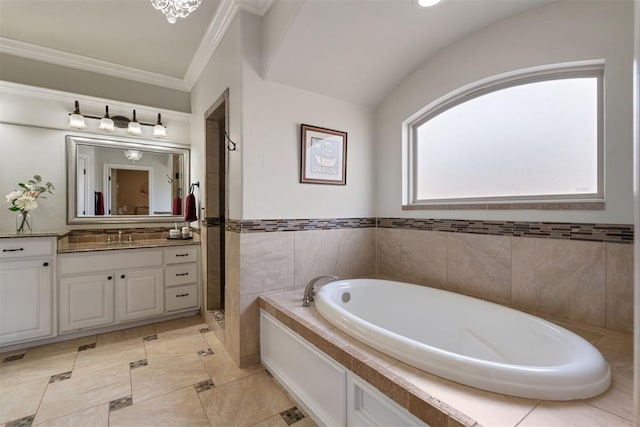 bathroom with crown molding, vanity, and tiled tub