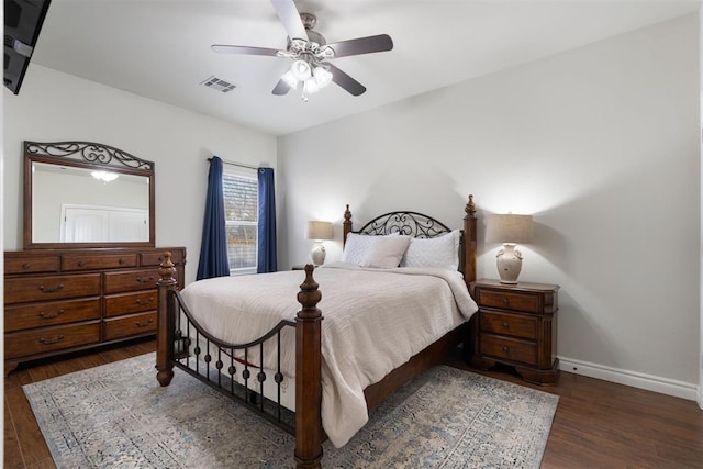 bedroom with ceiling fan and dark hardwood / wood-style flooring