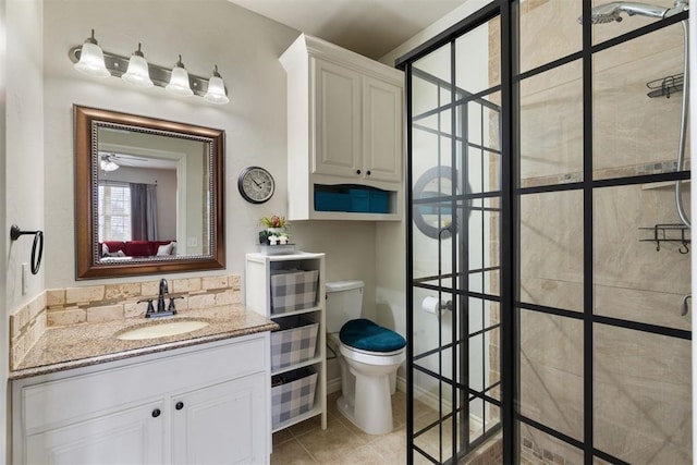 bathroom with walk in shower, vanity, toilet, and tile patterned flooring