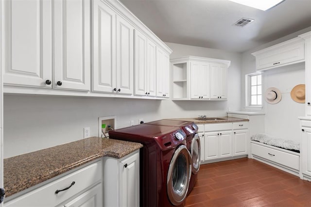 laundry room featuring cabinets, washer and dryer, sink, and dark hardwood / wood-style flooring