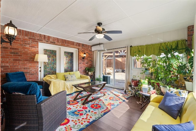 living room with dark hardwood / wood-style flooring, ceiling fan, and brick wall