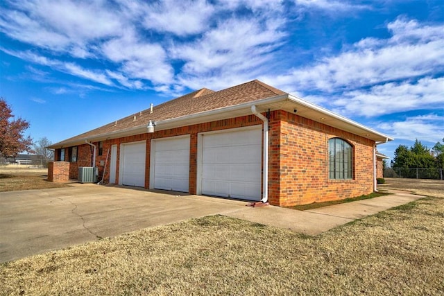 view of property exterior featuring cooling unit and a garage