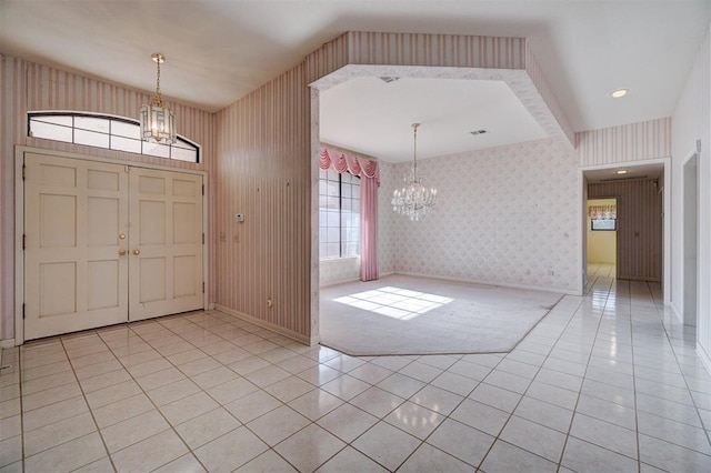 tiled foyer with a notable chandelier