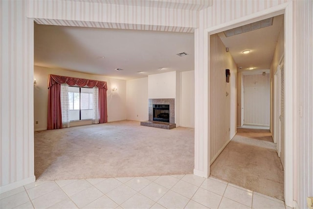 unfurnished living room featuring light colored carpet