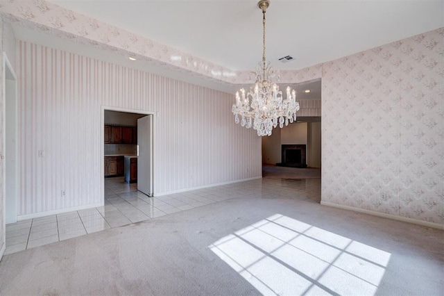 unfurnished dining area with light carpet and an inviting chandelier