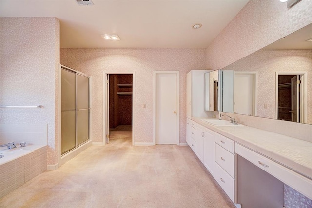 bathroom featuring vanity and shower with separate bathtub