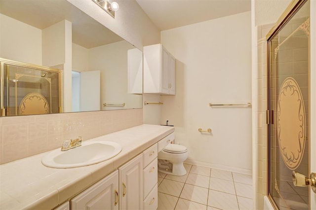 bathroom featuring tile patterned flooring, vanity, decorative backsplash, and toilet