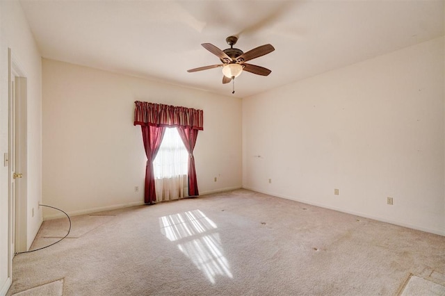 unfurnished room with light colored carpet and ceiling fan