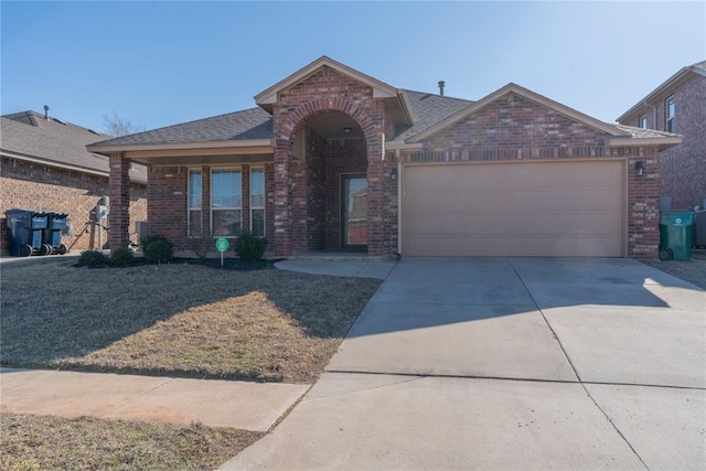 view of front facade featuring concrete driveway, brick siding, roof with shingles, and an attached garage