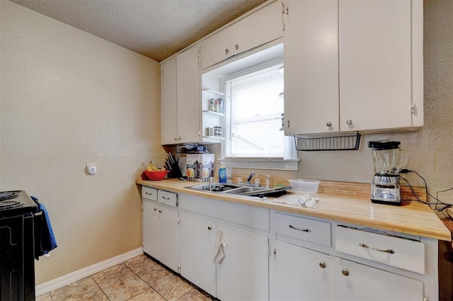 kitchen with white cabinetry, sink, black electric range oven, light tile patterned floors, and a textured ceiling