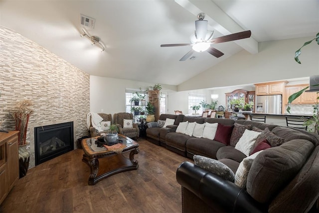 living room with dark hardwood / wood-style floors, high vaulted ceiling, beamed ceiling, a large fireplace, and ceiling fan