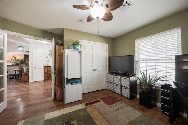 interior space with dark wood-type flooring and ceiling fan