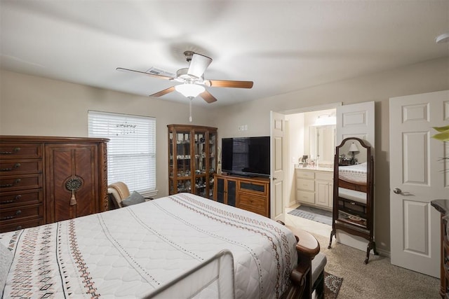 carpeted bedroom featuring connected bathroom and ceiling fan