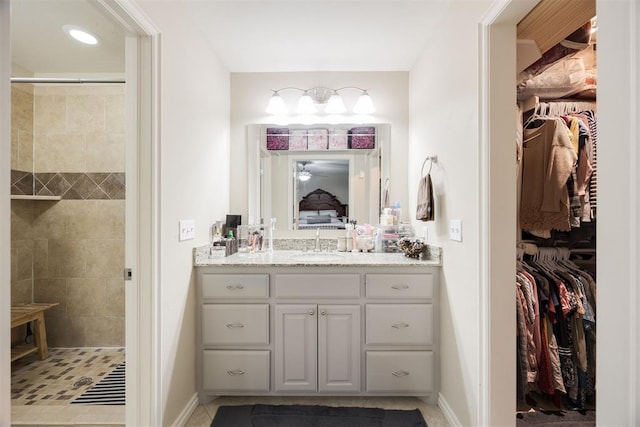 bathroom featuring vanity and a tile shower