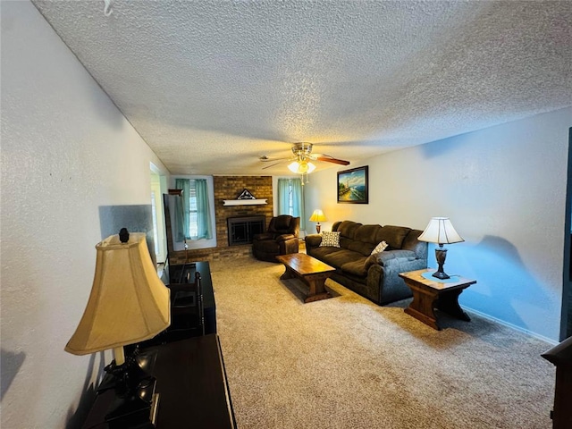 carpeted living room featuring ceiling fan, a brick fireplace, and a textured ceiling