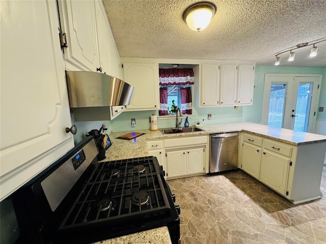 kitchen featuring sink, gas stove, a textured ceiling, stainless steel dishwasher, and kitchen peninsula