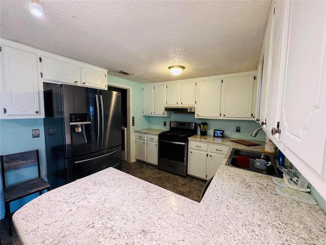 kitchen with refrigerator with ice dispenser, stainless steel electric range, sink, a textured ceiling, and white cabinets