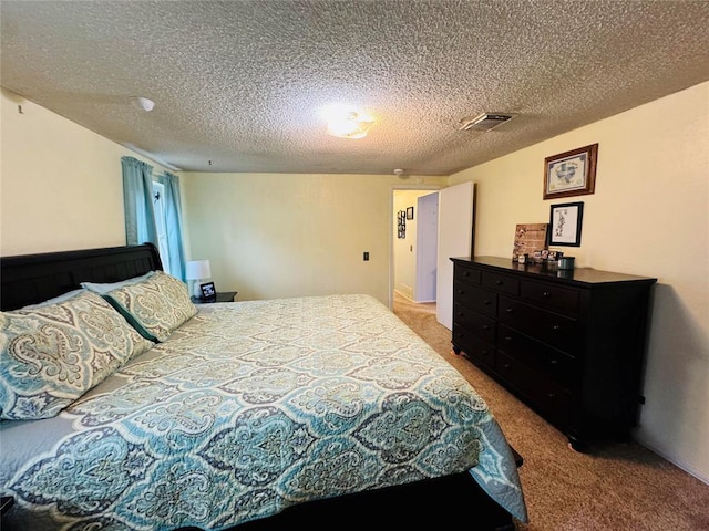 carpeted bedroom with a textured ceiling