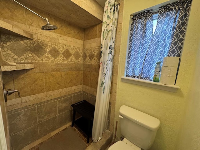 bathroom with a shower with curtain and toilet