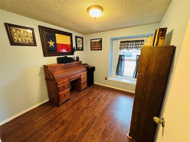 home office featuring dark hardwood / wood-style flooring and a textured ceiling