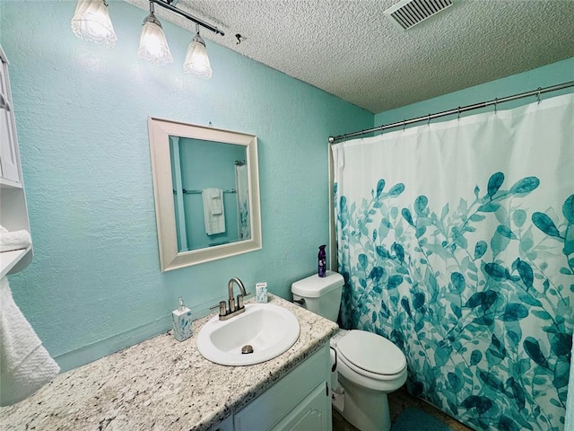 bathroom featuring vanity, toilet, a textured ceiling, and a shower with shower curtain