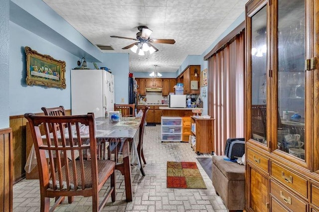 dining area with a textured ceiling and ceiling fan