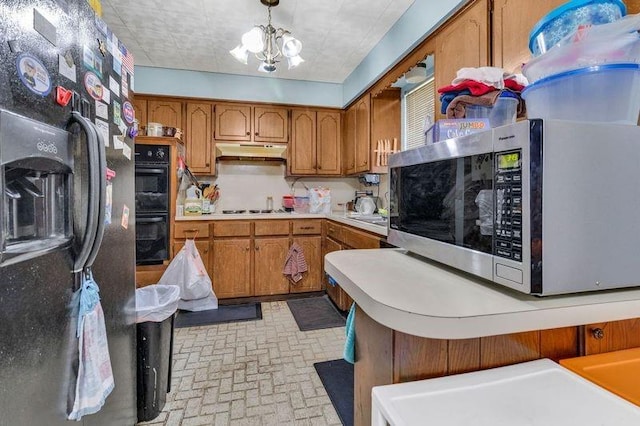 kitchen with pendant lighting, a chandelier, and black appliances