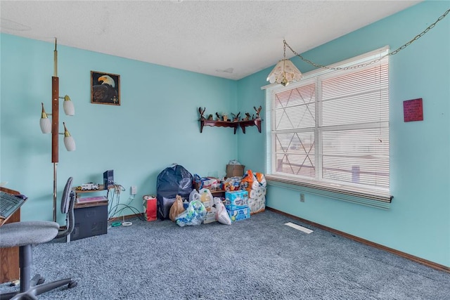 game room featuring carpet floors and a textured ceiling