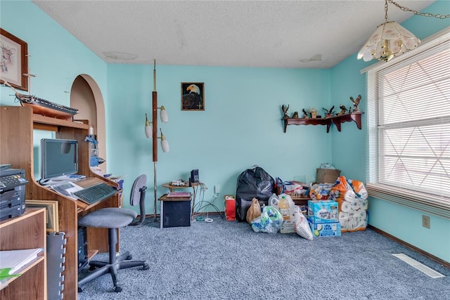 office space with a textured ceiling and carpet